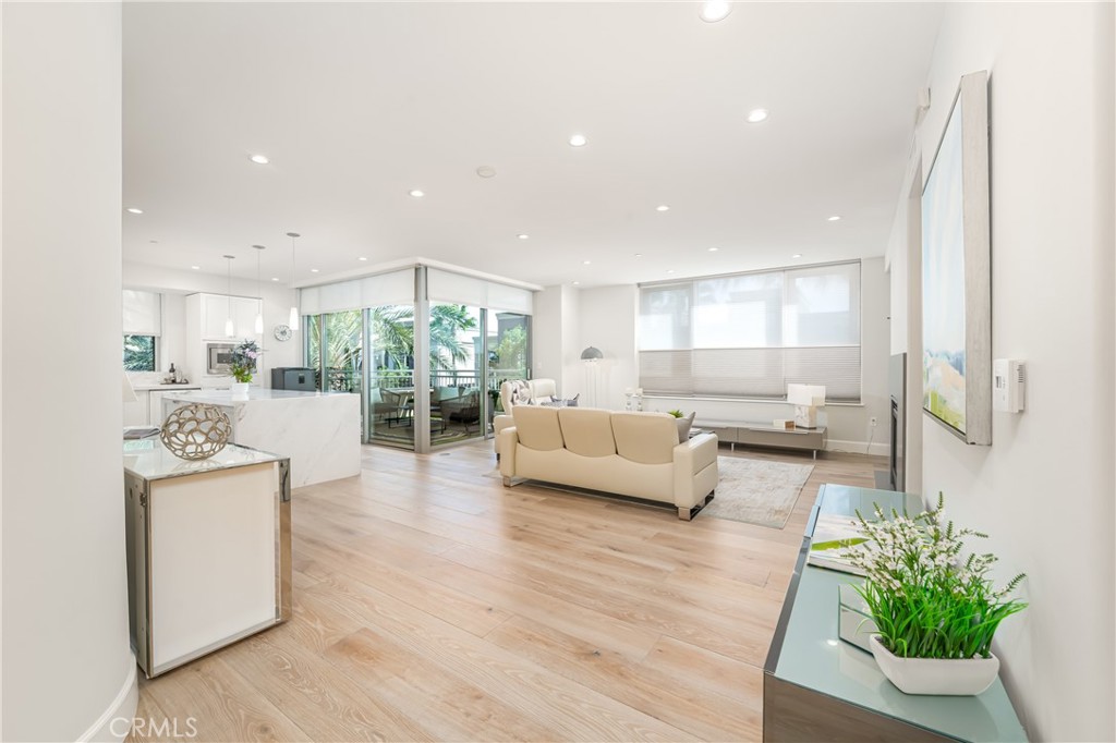 Large living room with fireplace with a wall of windows and large patio - 3043 Scholarship, Irvine CA 92612 - photo 7