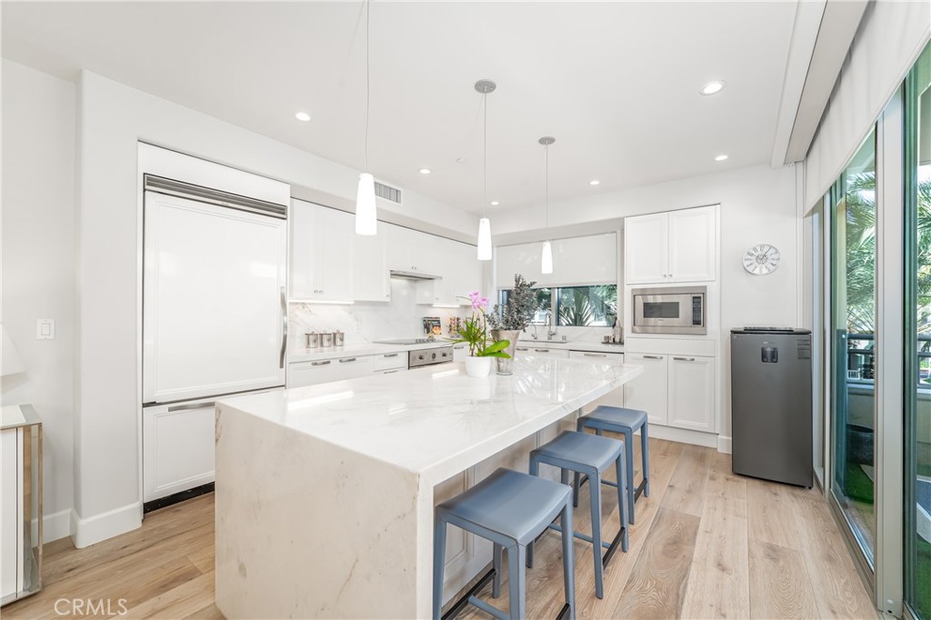 Remodeled kitchen with stone counters over gloss white lacquer Snaidero cabinetry. Sub-Zero refirgerator and Viking appl - 3043 Scholarship, Irvine CA 92612 - photo 10
