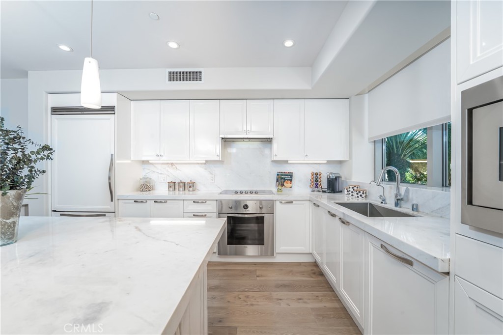 Remodeled kitchen with stone counters over gloss white lacquer Snaidero cabinetry. Sub-Zero refirgerator and Viking appl - 3043 Scholarship, Irvine CA 92612 - photo 11