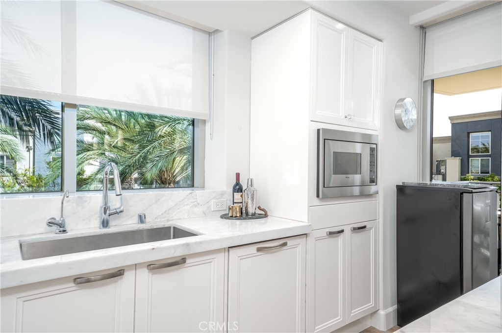 Remodeled kitchen with stone counters over gloss white lacquer Snaidero cabinetry. Sub-Zero refirgerator and Viking appl - 3043 Scholarship, Irvine CA 92612 - photo 13