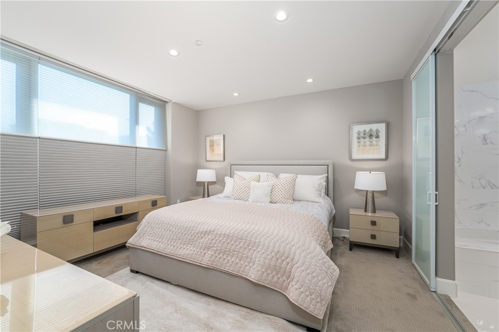 Gracious primary suite has a niche with a desk/vanity, remote control shades with top down/bottom up and day/night featu - 3043 Scholarship, Irvine CA 92612 - photo 18
