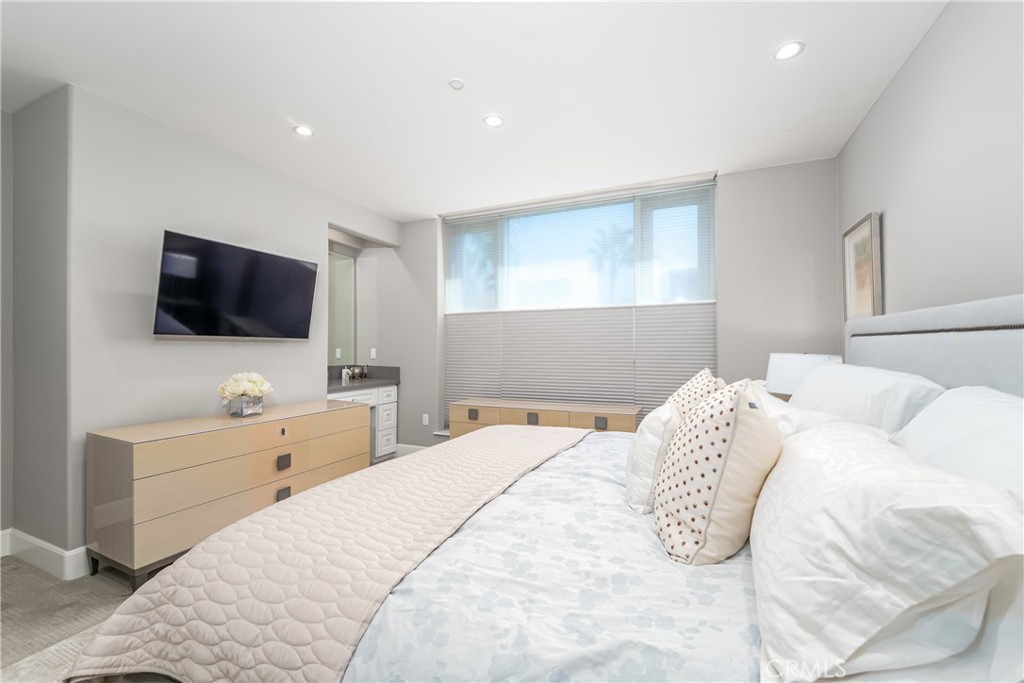 Gracious primary suite has a niche with a desk/vanity, remote control shades with top down/bottom up and day/night featu - 3043 Scholarship, Irvine CA 92612 - photo 19