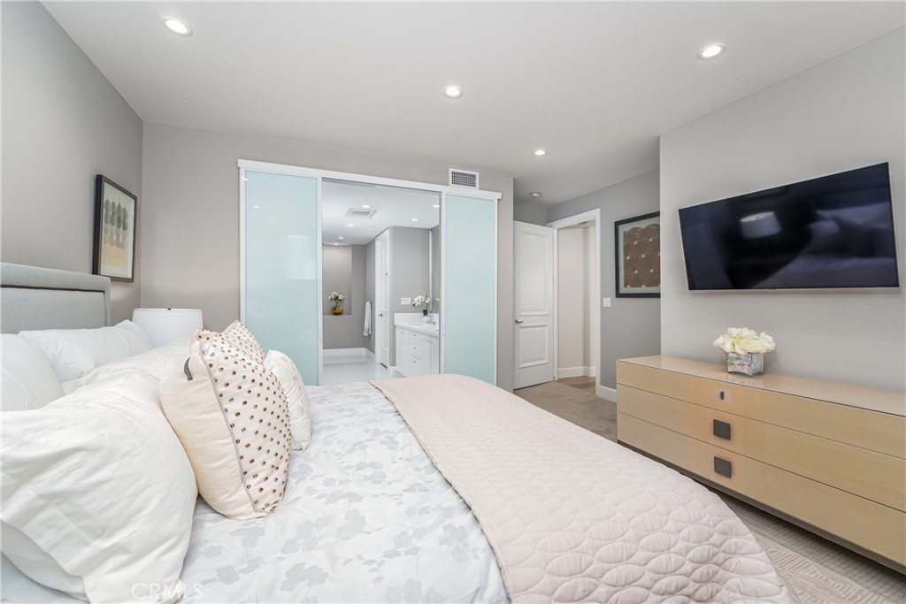 Gracious primary suite has a niche with a desk/vanity, remote control shades with top down/bottom up and day/night featu - 3043 Scholarship, Irvine CA 92612 - photo 20