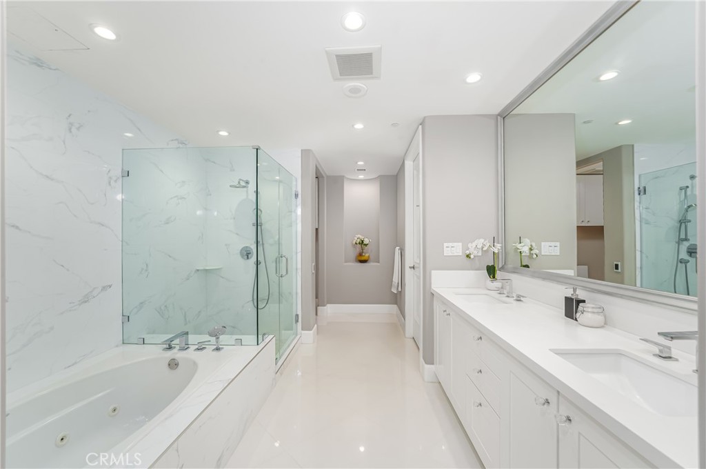 Remodeled primary bath with heated tile floor, dual sink vanity, jetted tub, shower with bench - 3043 Scholarship, Irvine CA 92612 - photo 21