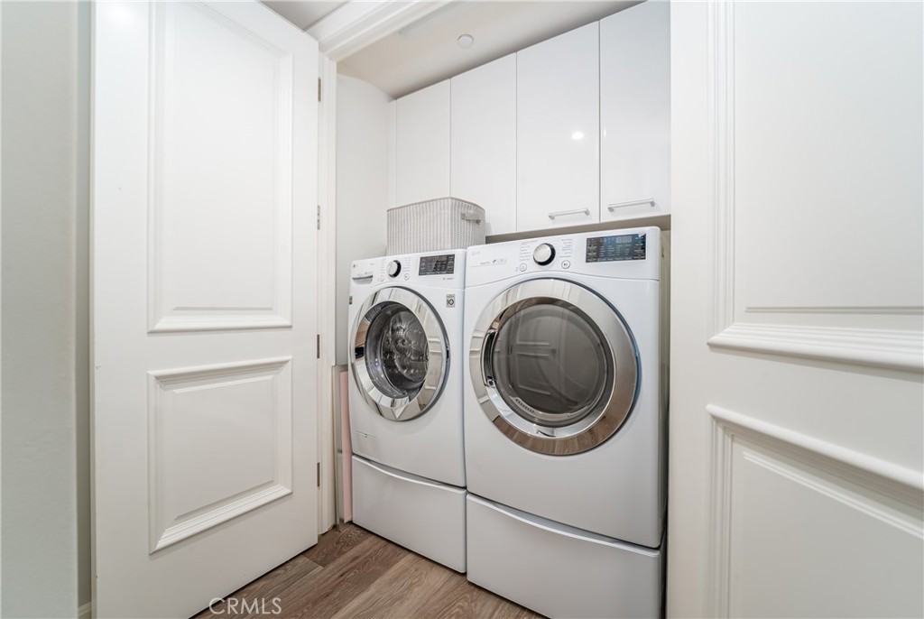 Laundry closet with storage cabinets above and large closet just across - 3043 Scholarship, Irvine CA 92612 - photo 28