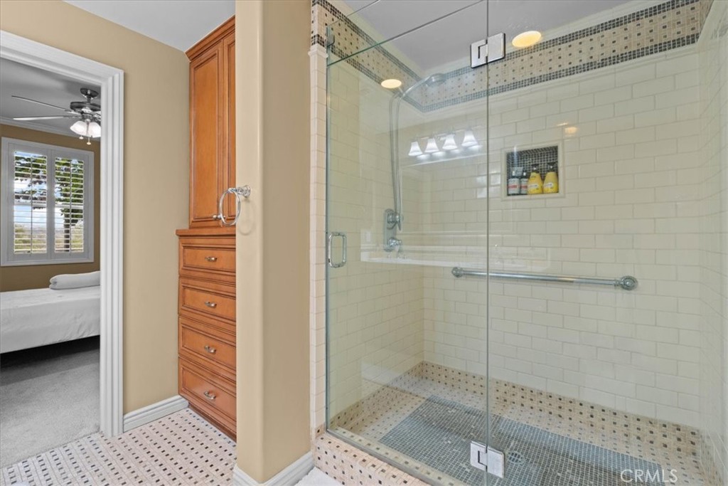 Shower and custom built in storage in primary bathroom 1 - 3160 Watermarke, Irvine CA 92612 - photo 37