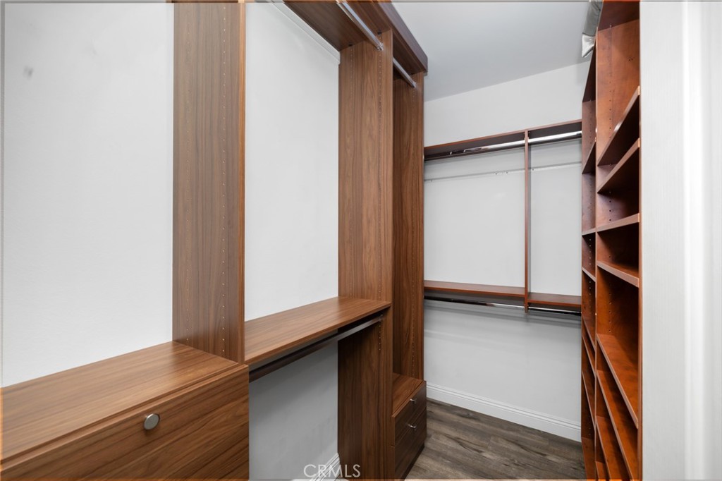 Primary En-Suite Walk-In Closet with Custom Cabinetry - 3407 Ladrillo Aisle, Irvine CA 92606 - photo 18
