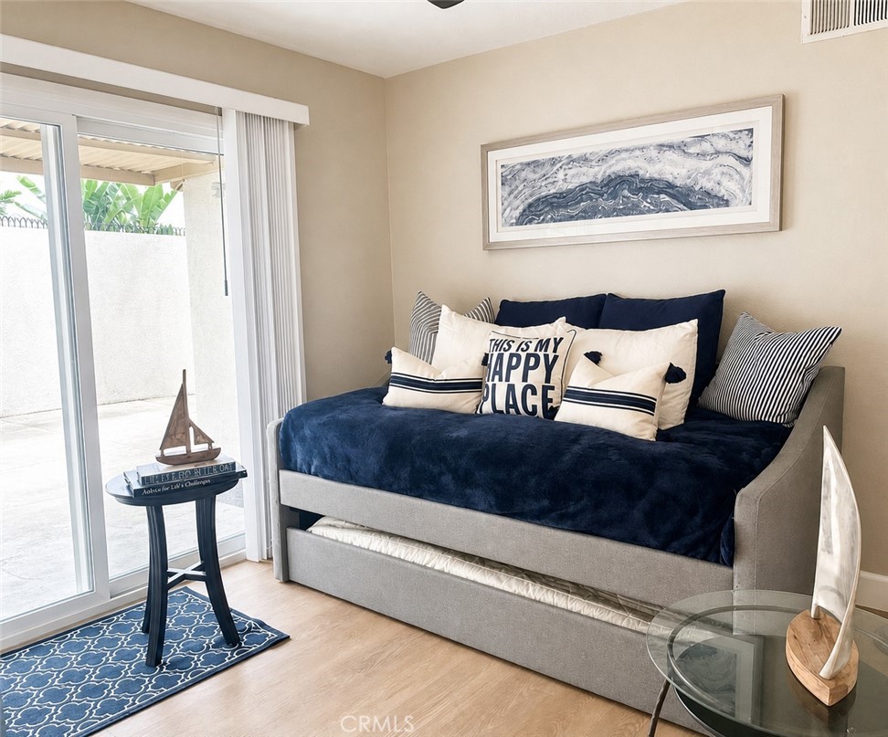 First bedroom. Slider leads out to the backyard. Bedroom has lighted ceiling fan. - 4212 Fireside, Irvine CA 92604 - photo 10