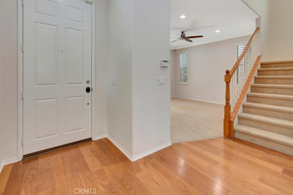 Entrance leads into living room with crackling fireplace, French doors to front patio - 47 Canopy, Irvine CA 92603 - photo 5