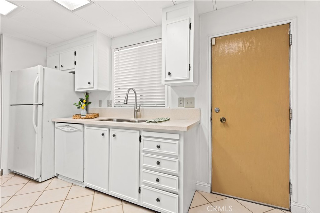 Kitchen w/door to carport - 5200 Irvine Boulevard 254, Irvine CA 92620 - photo 13