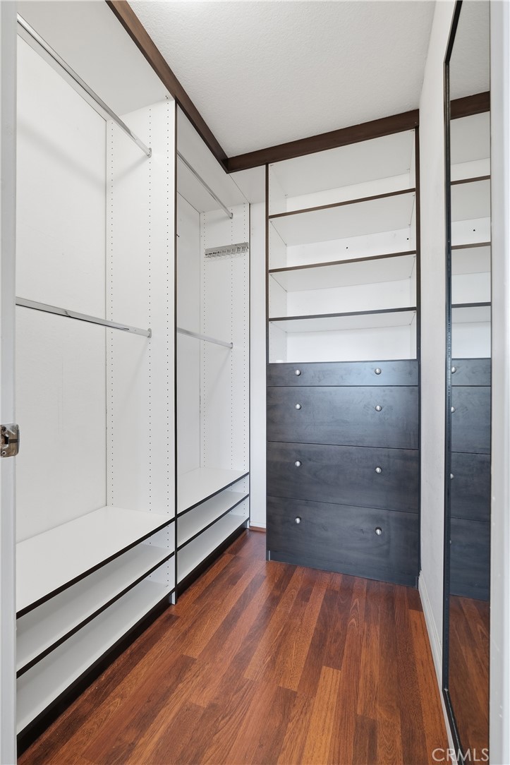 Walk-in closet in primary bedroom - 54 Oval Road, Irvine CA 92604 - photo 19