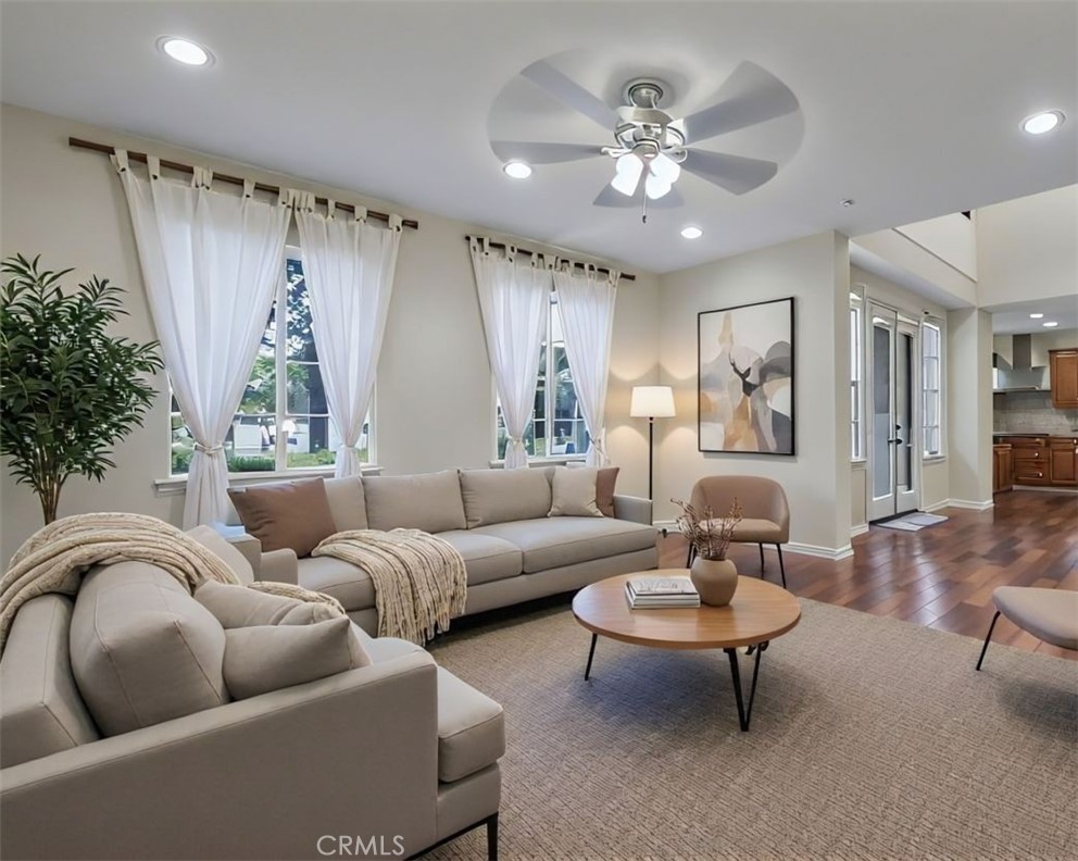 Living room with elegant finishes and abundant natural light—perfect for entertaining or relaxing. Digitally staged furn - 54 Tea Garden, Irvine CA 92620 - photo 1