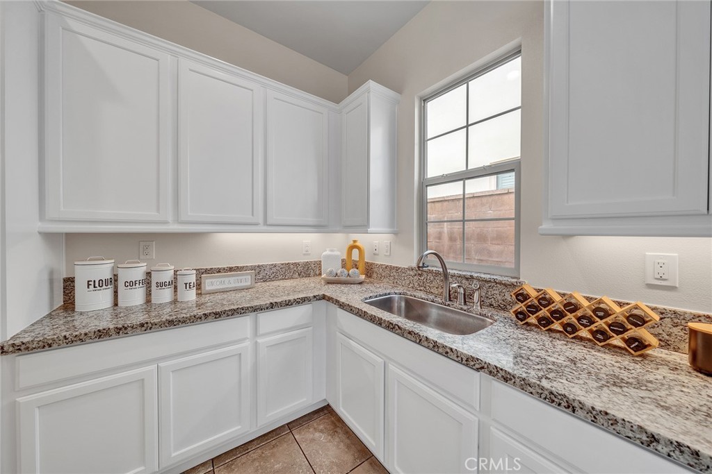 The main kitchen features a second sink and abundant cabinetry for added convenience and storage - 60 Sherwood, Irvine CA 92620 - photo 16