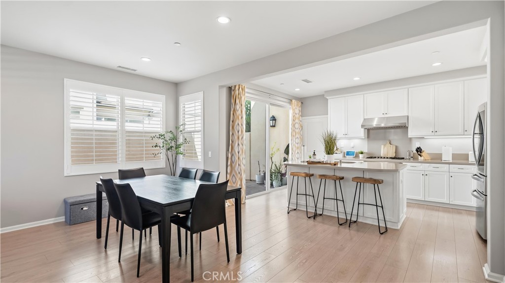 Open dining and kitchen areas - 66 Fairymoss, Irvine CA 92620 - photo 6
