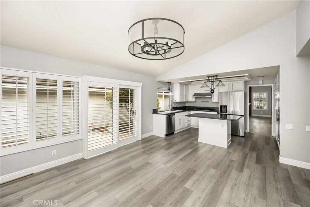 Family room to kitchen with walls of windows and plantation shutters - 7 Atlanta, Irvine CA 92620 - photo 4