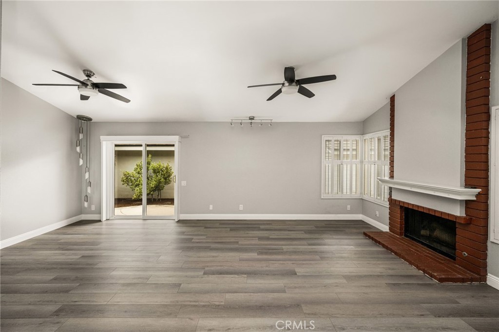 Another view of the living room and brick fireplace. The plantation shutters will be reinstalled soon! - 7 Atlanta, Irvine CA 92620 - photo 7