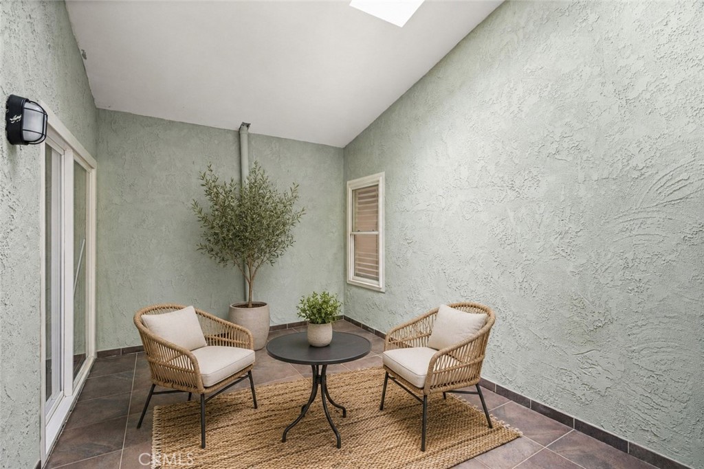 Virtually staged atrium, or maybe make it a sofa creating a reading nook - 7 Atlanta, Irvine CA 92620 - photo 12