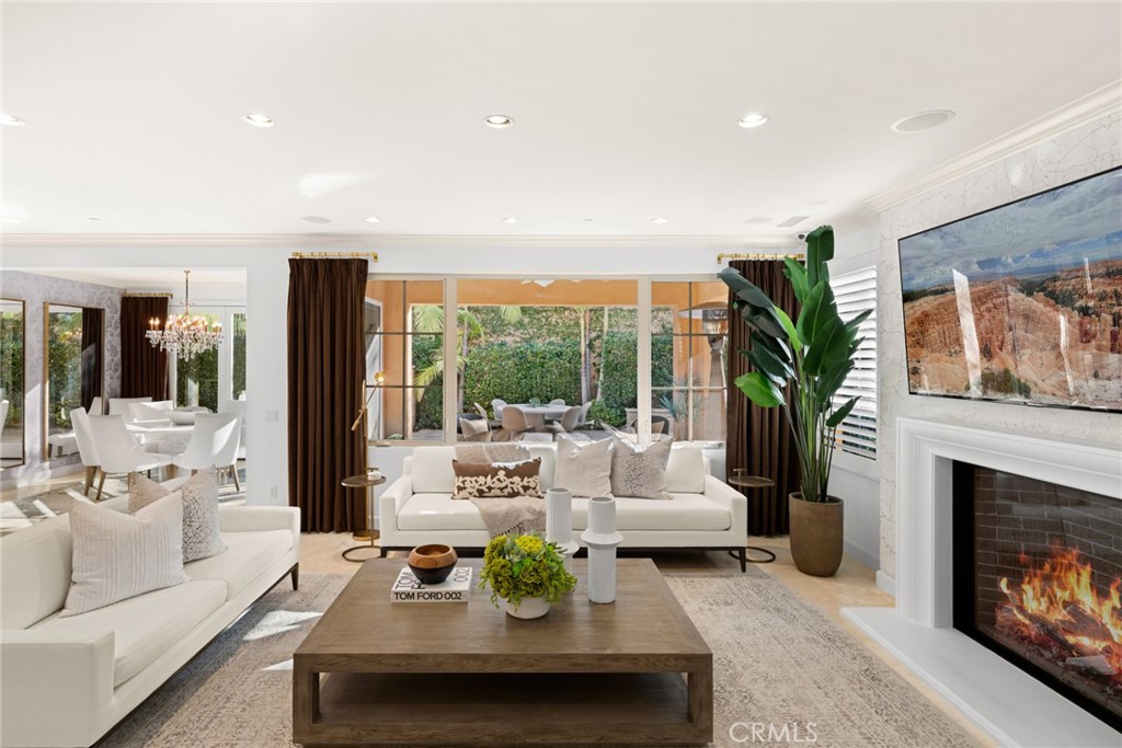 A large fireplace is a focul point in the family room, where evenings with loved ones, fun-filled movie nights and envia - 70 Livia, Irvine CA 92618 - photo 1
