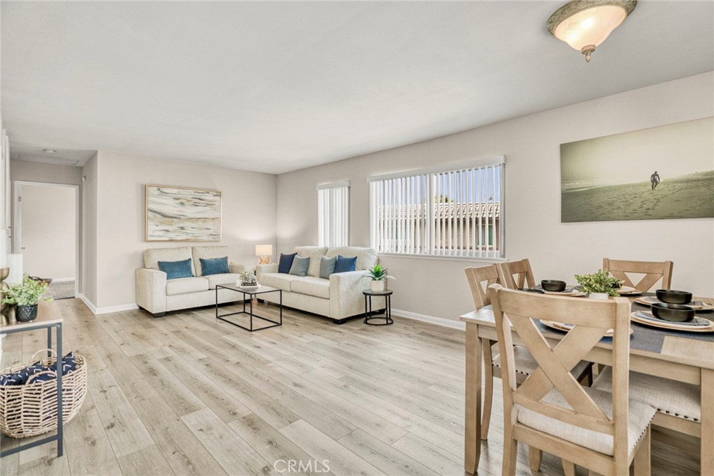 Upon entry, this home offers an open floorplan where the living room flows into the dining area and kitchen. - 1064 Las Lomas Drive D, La Habra CA 90631 - photo 4