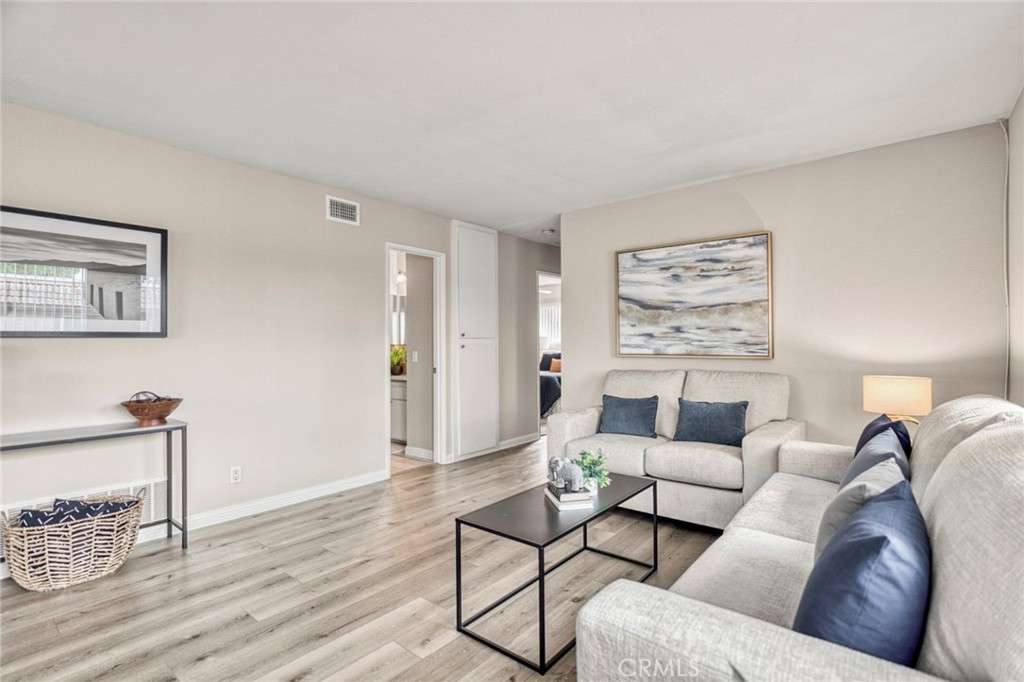 Luxury laminate flooring flows throughout the living areas, adding a touch of modern style while offering a cohesive loo - 1064 Las Lomas Drive D, La Habra CA 90631 - photo 6