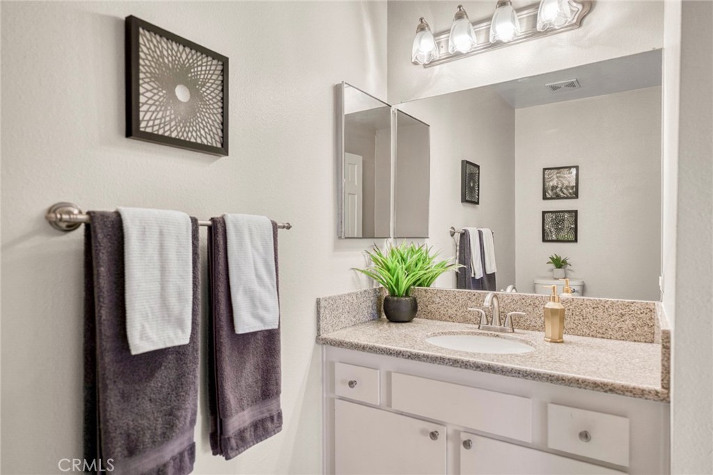 Conveniently located near the living area, the half bath features a granite countertop and provides a practical, stylish - 1064 Las Lomas Drive D, La Habra CA 90631 - photo 11
