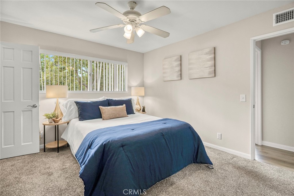 The primary suite offers a comfortable space, complete with a full bathroom, a walk-in closet, and an additional closet - 1064 Las Lomas Drive D, La Habra CA 90631 - photo 12