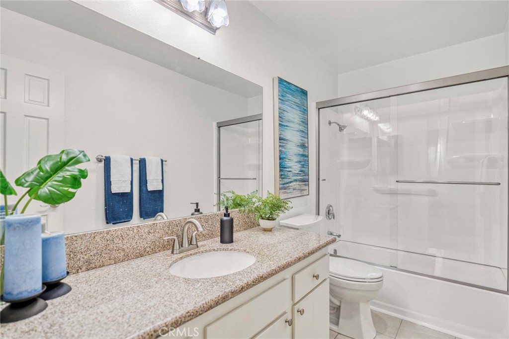 Bathroom improvements include a reglazed bathtub, new shower fixtures, and a new shower enclosure. The en suite bath als - 1064 Las Lomas Drive D, La Habra CA 90631 - photo 14