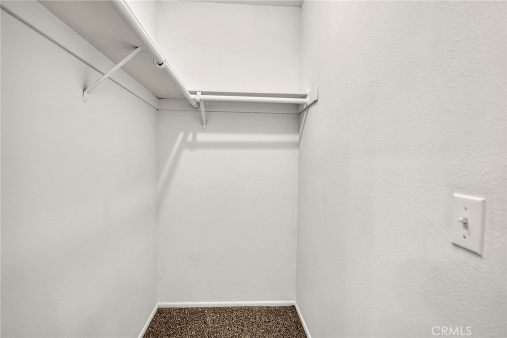 The spacious walk-in closet in the primary bedroom offers convenient storage and organization for clothing, shoes, and a - 1064 Las Lomas Drive D, La Habra CA 90631 - photo 15