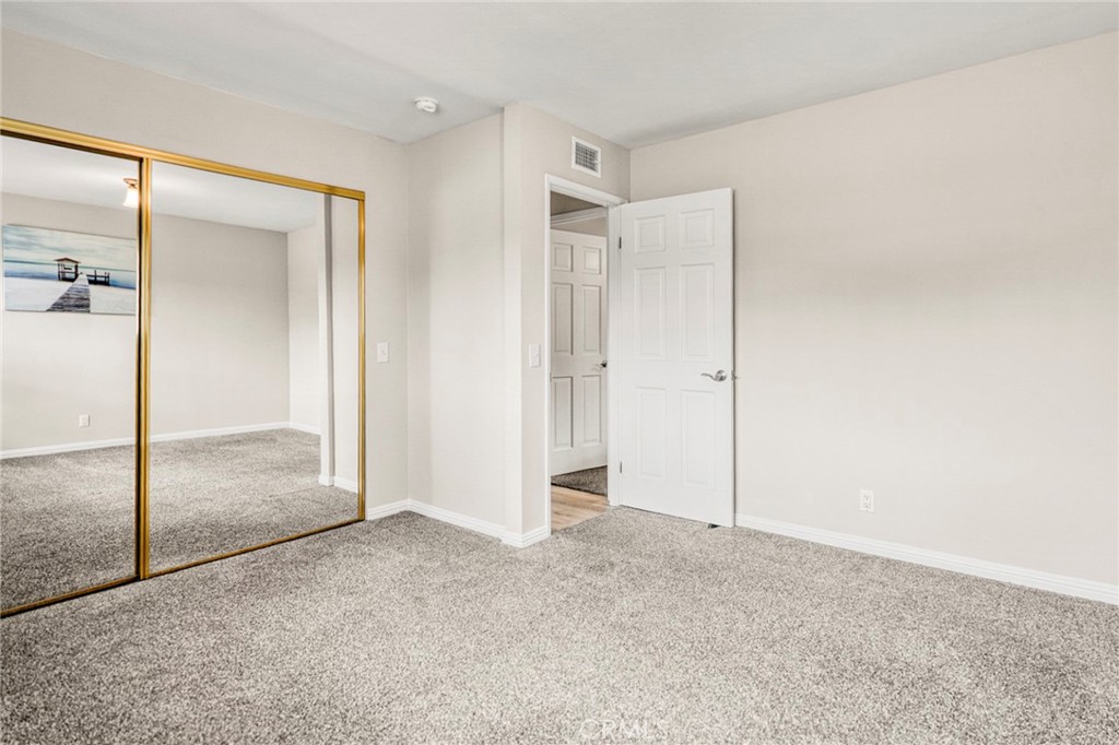 The second bedroom also features mirrored closet doors and offers flexibility for guests, a home office, or additional l - 1064 Las Lomas Drive D, La Habra CA 90631 - photo 16