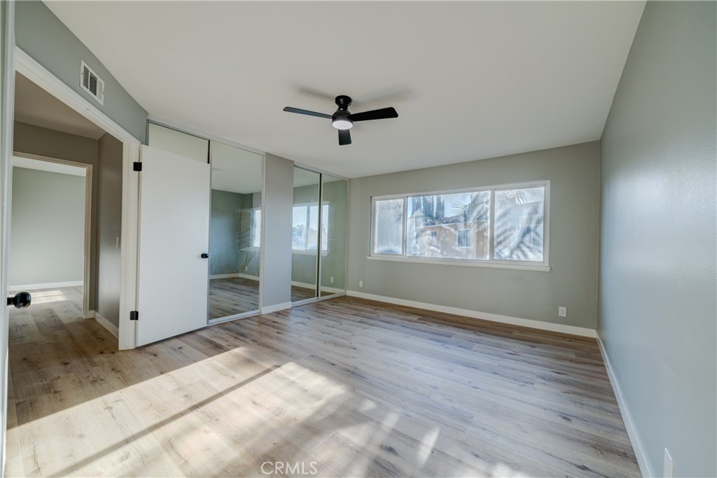 Primary bedroom with mirrored closets and large windows - 750 Hartford Lane, La Habra CA 90631 - photo 21