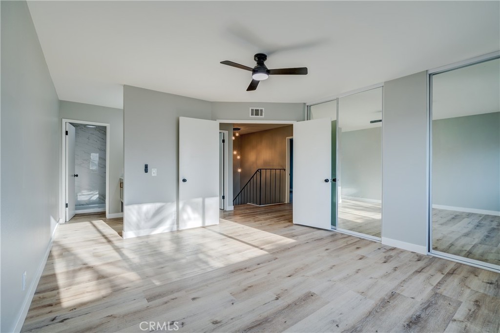 Spacious primary bedroom with mirrored closets and en-suite bathroom - 750 Hartford Lane, La Habra CA 90631 - photo 22