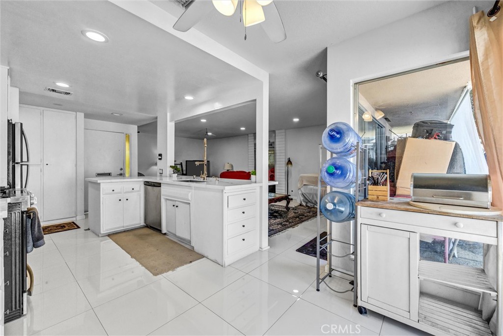 White cabinetry, generous counter space, and stainless steel appliances, including a gas range. - 919 Glencliff, La Habra CA 90631 - photo 5