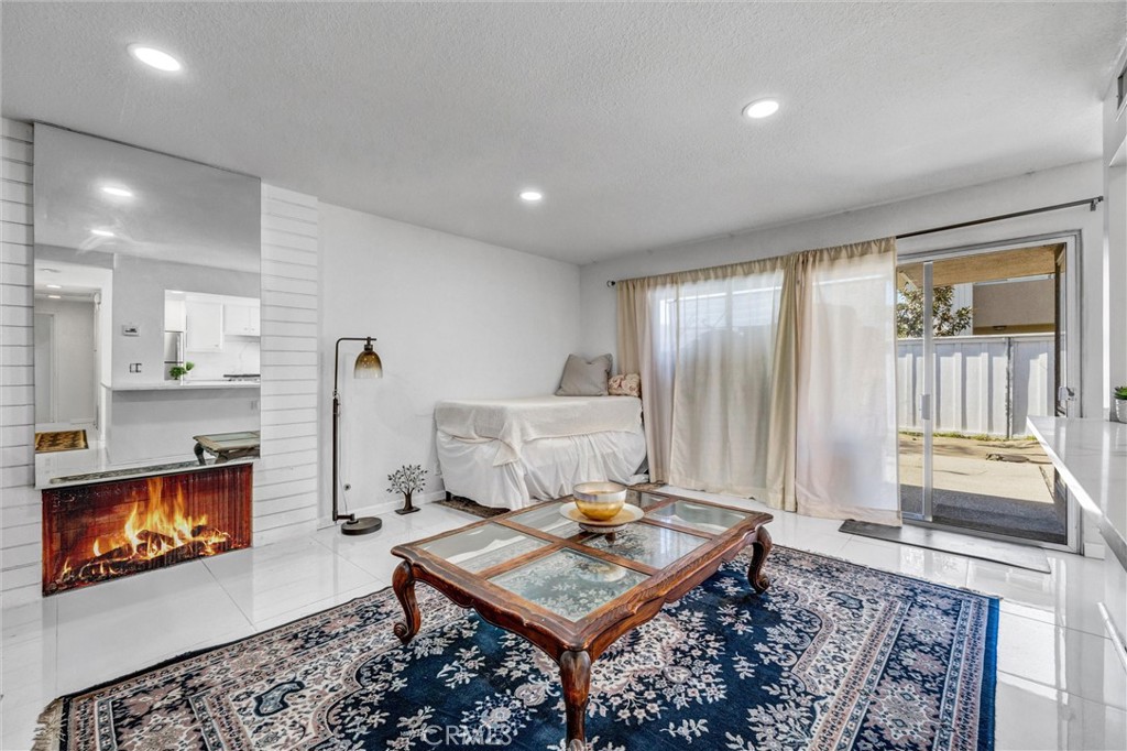 Another view featuring a fireplace, natural light, and sliding glass doors leading to the private backyard. - 919 Glencliff, La Habra CA 90631 - photo 19