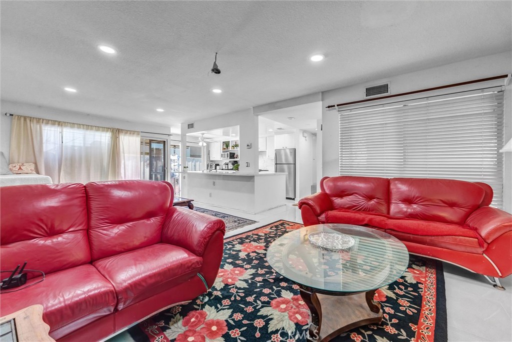 Comfortable seating area with recessed lighting and an open layout connecting to the kitchen. - 919 Glencliff, La Habra CA 90631 - photo 20