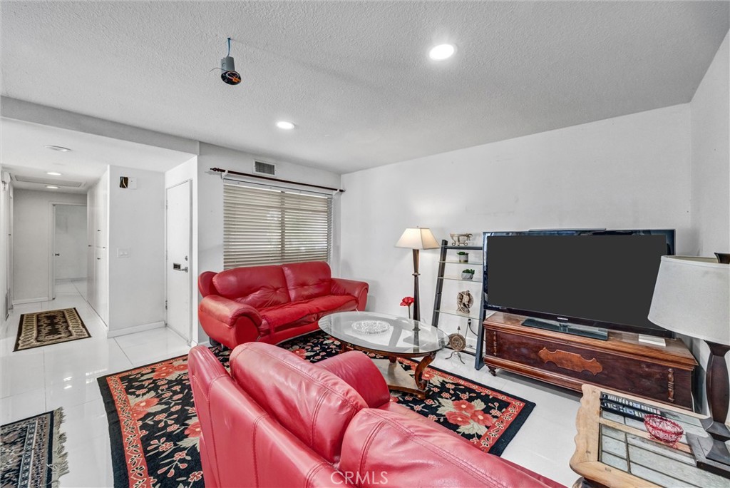 Another angle showing the generous living space, natural light, and flexible furniture arrangement. - 919 Glencliff, La Habra CA 90631 - photo 21