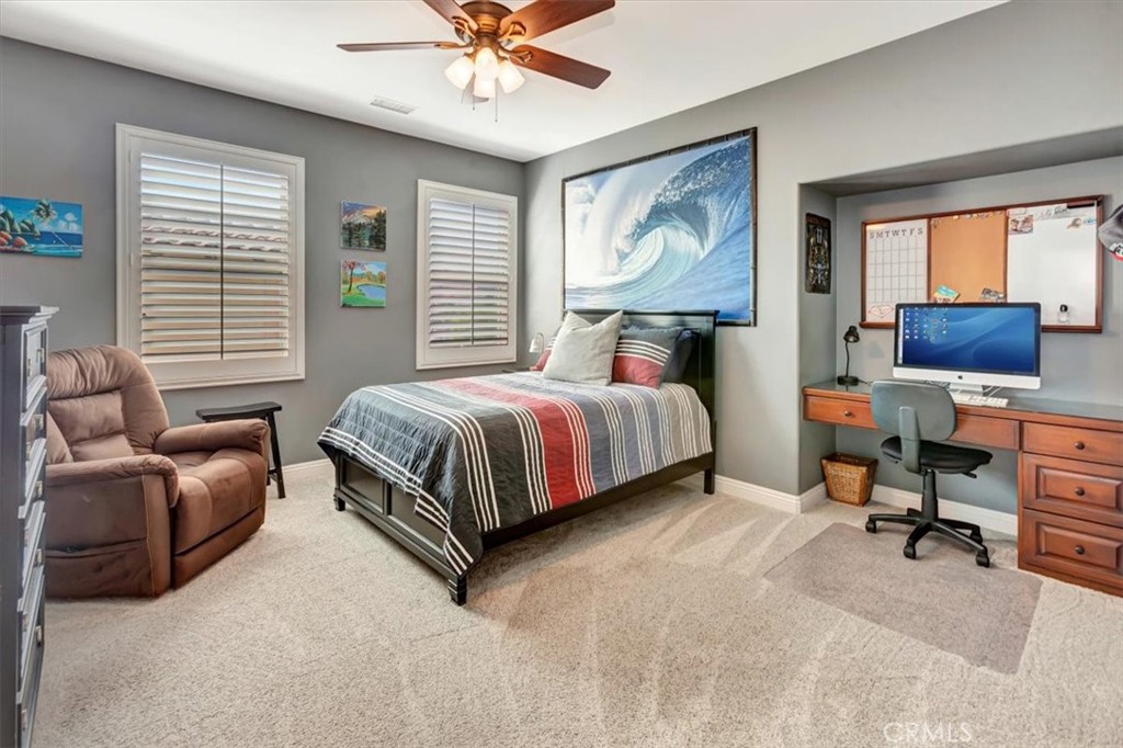 Bedroom 3 with built-in desk and a walk-in closet. - 15 Julia Street, Ladera Ranch CA 92694 - photo 30