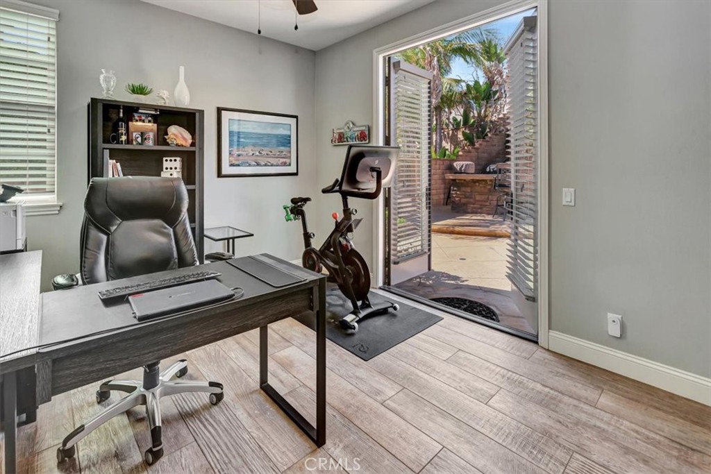 Downstairs bedroom featuring direct yard access and custom built-in cabinetry for entertainment and storage. - 15 Julia Street, Ladera Ranch CA 92694 - photo 33