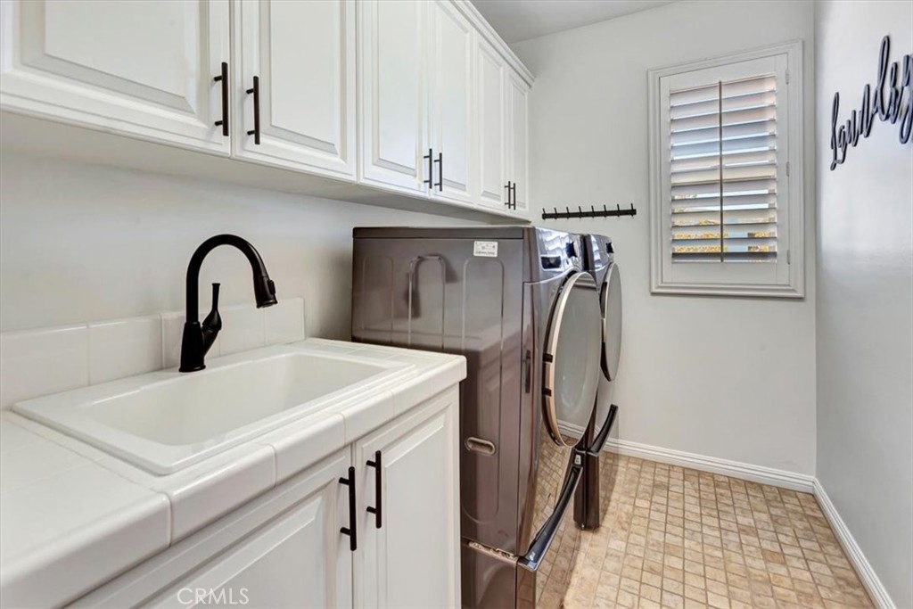 Spacious laundry room with sink & cabinets. - 15 Julia Street, Ladera Ranch CA 92694 - photo 35