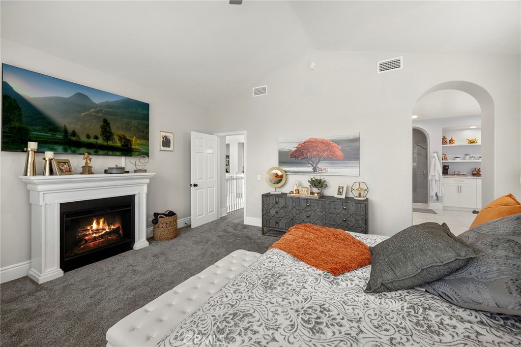 Primary bedroom with fireplace. (Digitally enhanced fire). - 16 Kempton Lane, Ladera Ranch CA 92694 - photo 38