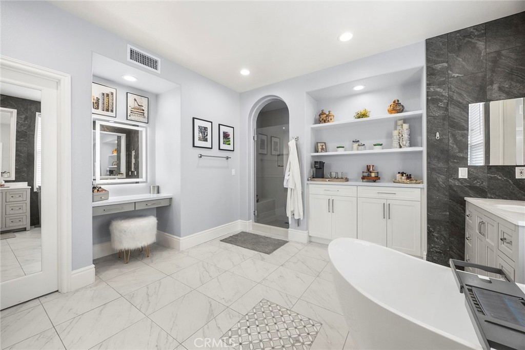 Luxury primary bathroom with custom vanity lighting. - 16 Kempton Lane, Ladera Ranch CA 92694 - photo 42