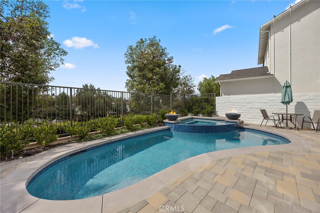 Recently updated pool and spa with pebble tech coating and fire bowls. (Digitally enhanced fire). - 16 Kempton Lane, Ladera Ranch CA 92694 - photo 52