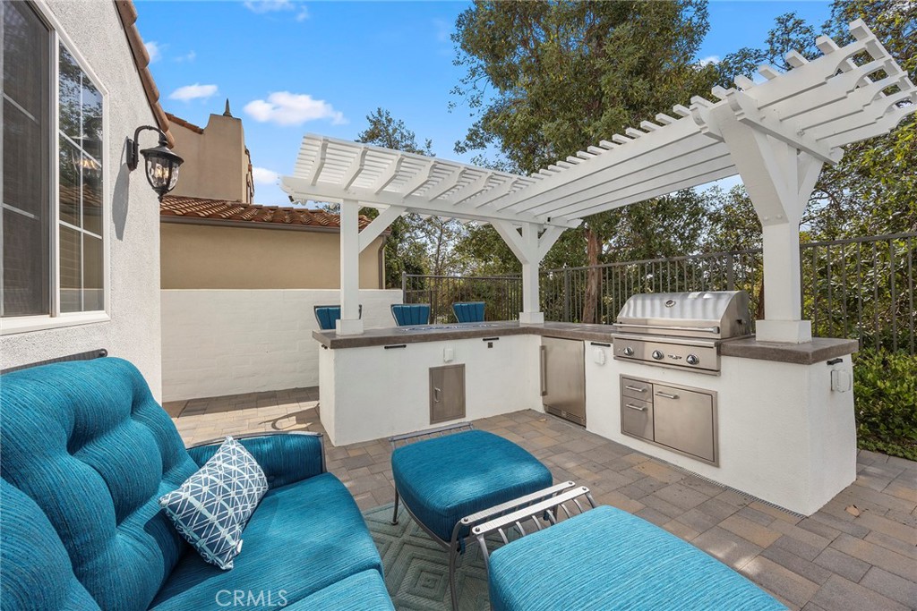 Recently constructed BBQ island with lattice cover, refrigerator, and fire feature. - 16 Kempton Lane, Ladera Ranch CA 92694 - photo 56