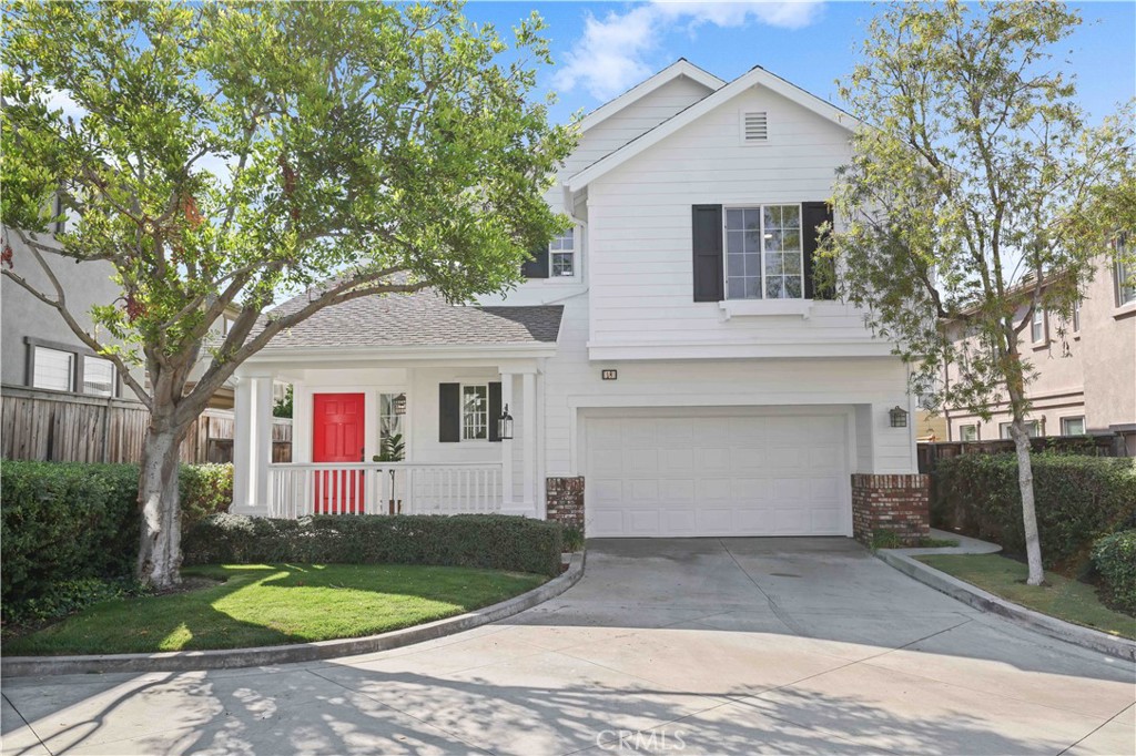 Recently refreshed with a modern farmhouse exterior featuring crisp white siding, black shutters, and a welcoming red do - 18 Ash Hollow Trail, Ladera Ranch CA 92694 - photo 1