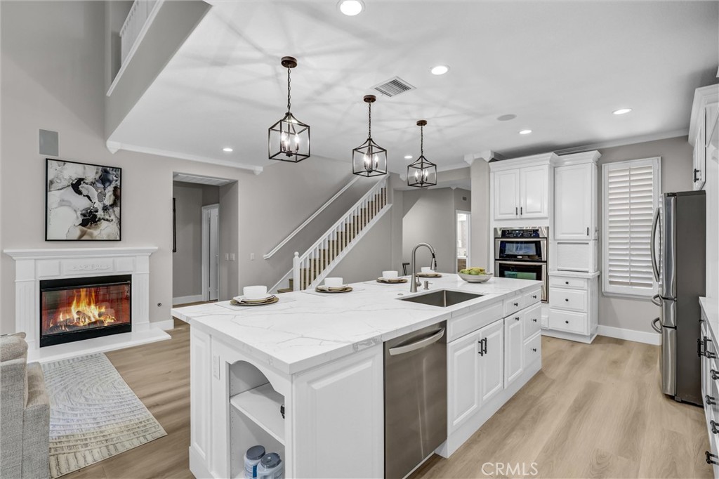 Chief's kitchen; NEW countertops & backsplash. Fireplace flame is ai enhanced. - 2 St. Giles, Ladera Ranch CA 92694 - photo 7