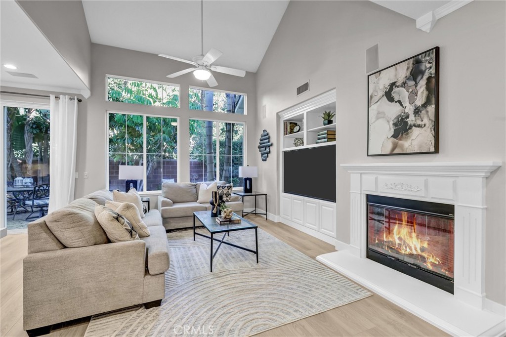 Cozy fireplace in living room. Fireplace flame is ai enhanced. - 2 St. Giles, Ladera Ranch CA 92694 - photo 8