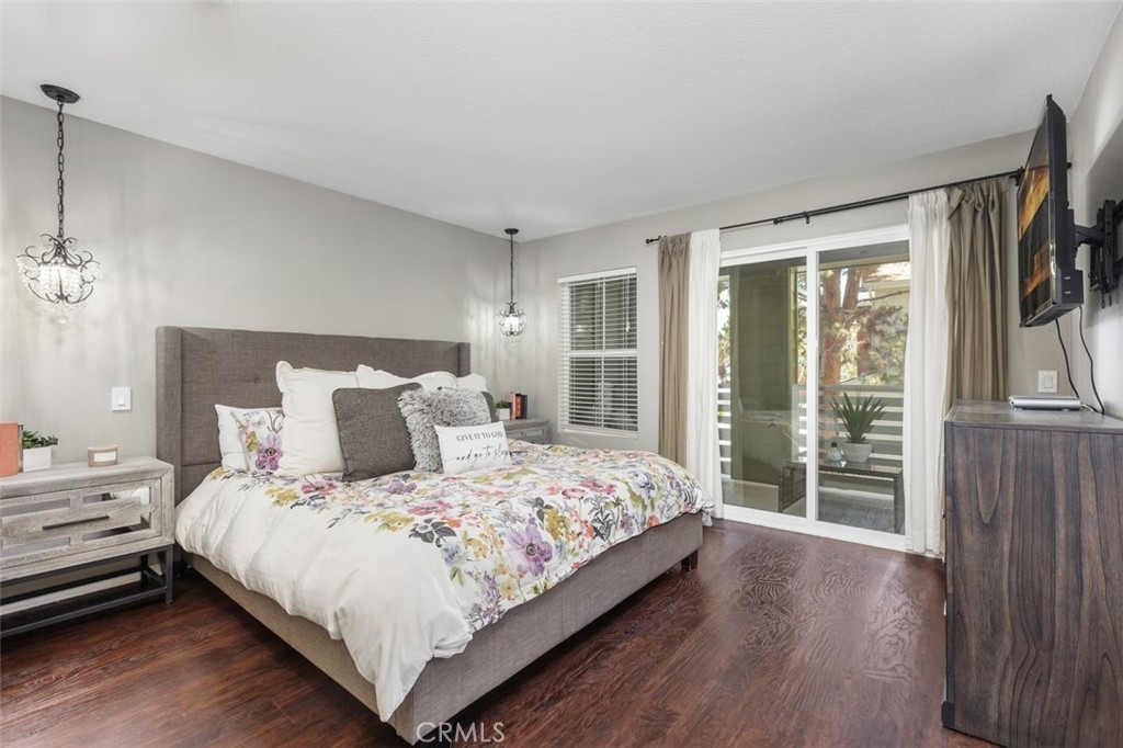 Spacious primary bedroom , accented with beautiful wood flooring, relaxing patio and large walk in closet. - 25 Platinum, Ladera Ranch CA 92694 - photo 21