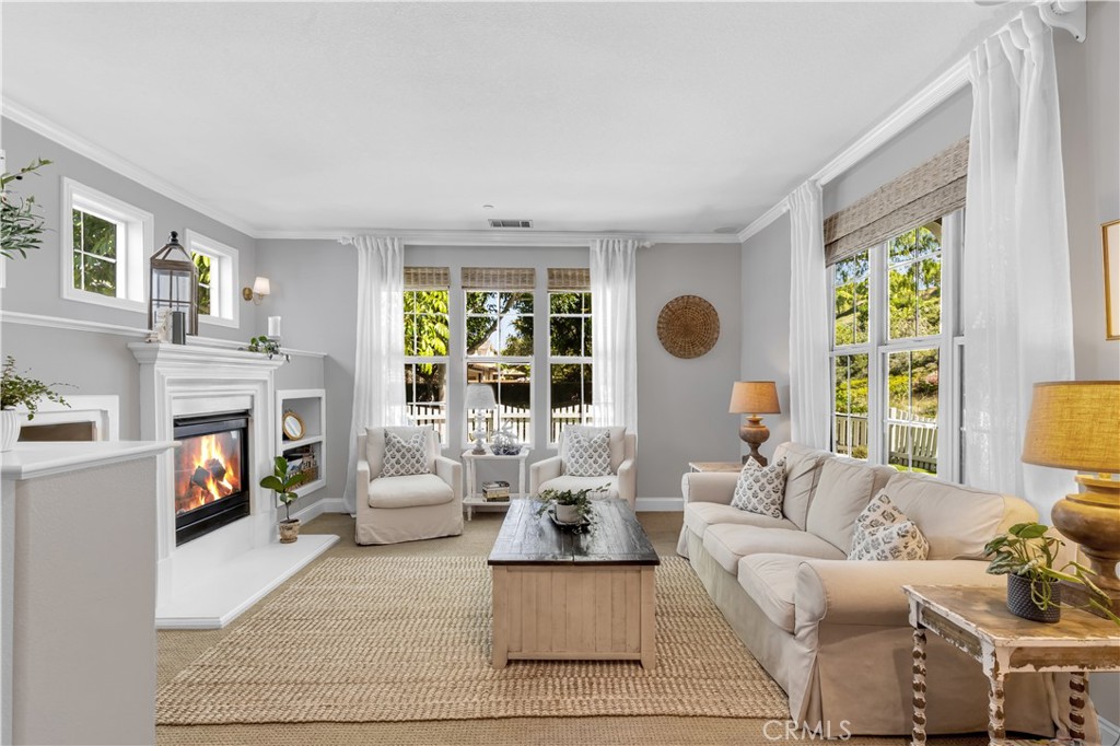 Family room features fireplace, crown moulding + fills with natural light - 5 Surrey Farm, Ladera Ranch CA 92694 - photo 8