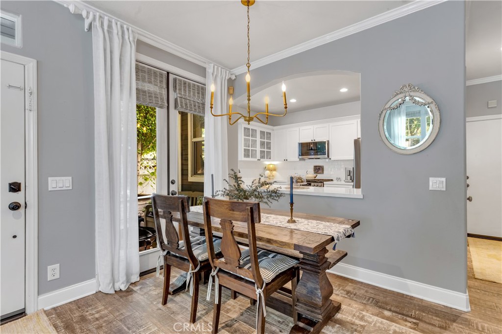Dining Area with chic gold light fixture and French Doors to private​​‌​​​​‌​​‌‌​​‌‌​​‌‌​​‌​​​‌‌​‌​​​​‌‌​‌​​ patio. - 5 Surrey Farm, Ladera Ranch CA 92694 - photo 24