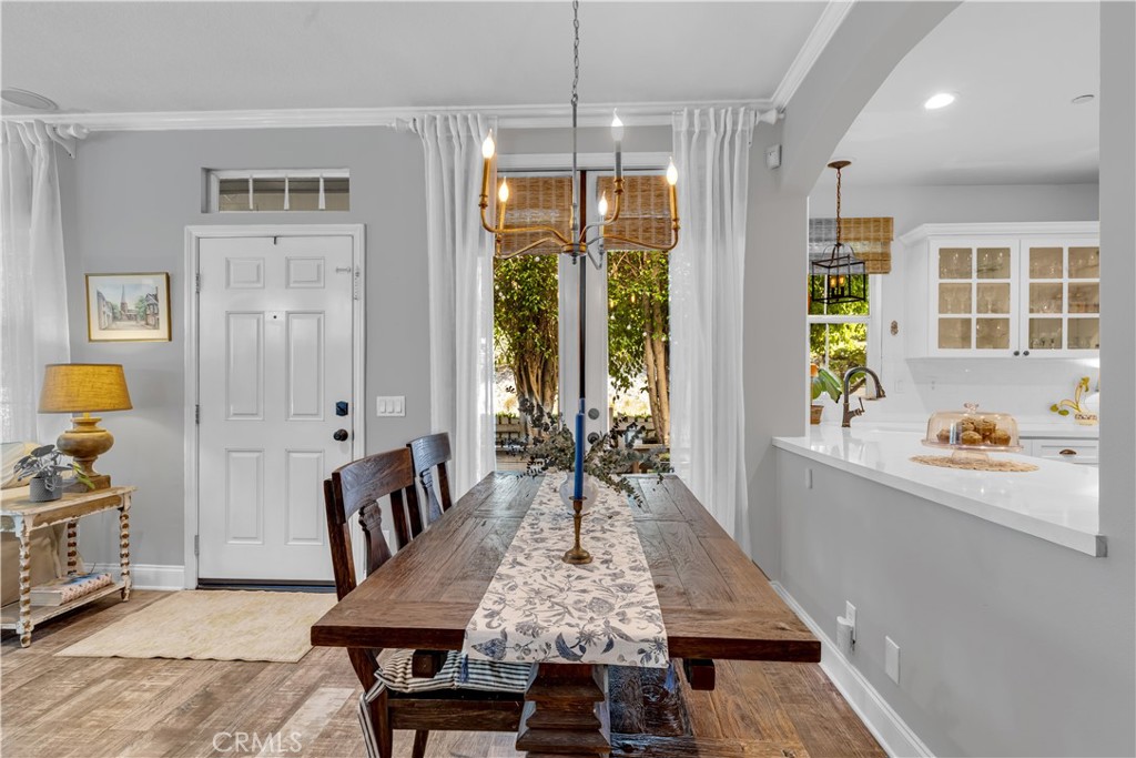 Dining Area with chic gold light fixture and French Doors to private patio. - 5 Surrey Farm, Ladera Ranch CA 92694 - photo 25