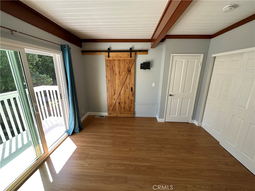 Main bedroom with barn door to bathroom and lots of closet space. Also has deck over backyard - 1064 Santa Ana, Laguna Beach CA 92651 - photo 7